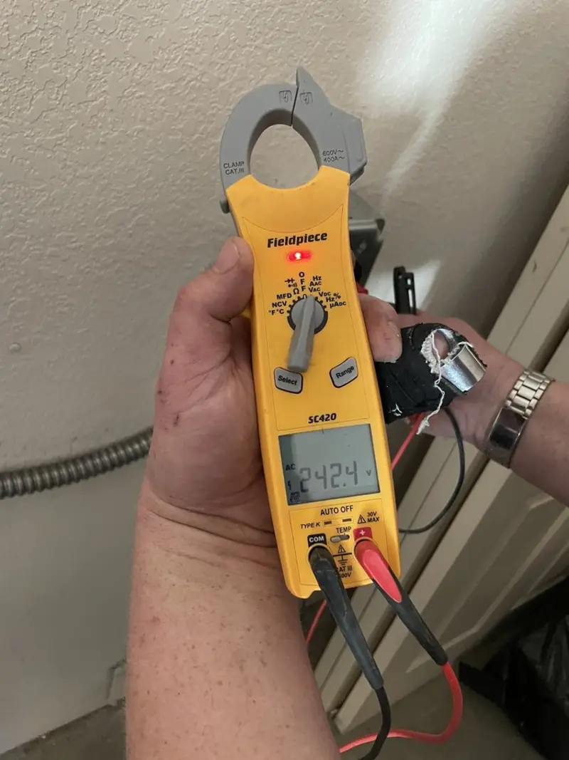 Voltage testing with clamp meter during Recessed Lighting Installation in Palm Beach Gardens